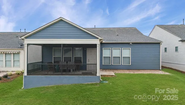 a front view of a house with a garden and yard