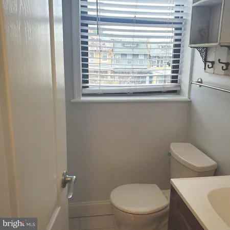 a white toilet sitting next to a window