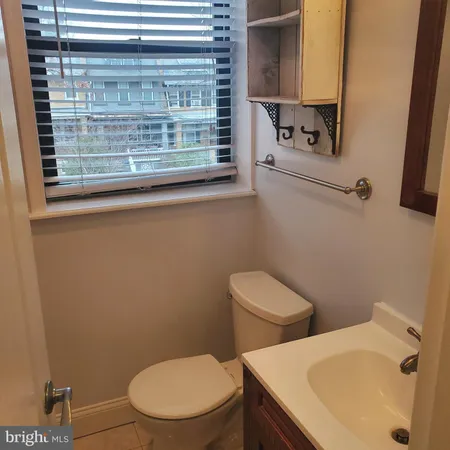 a white toilet sitting next to a bathroom sink