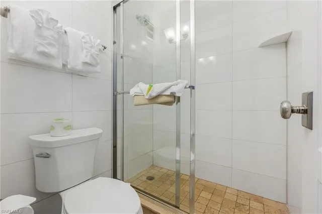 a bathroom with a shower a toilet and sink