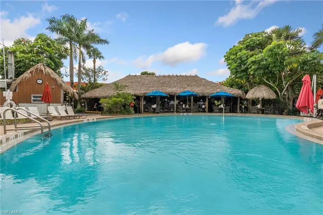 a view of house with garden space and swimming pool