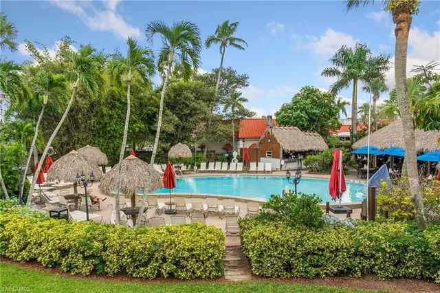 an outdoor space with seating area and swimming pool