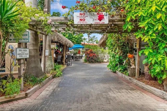 a couple of people sitting in front of retail shops