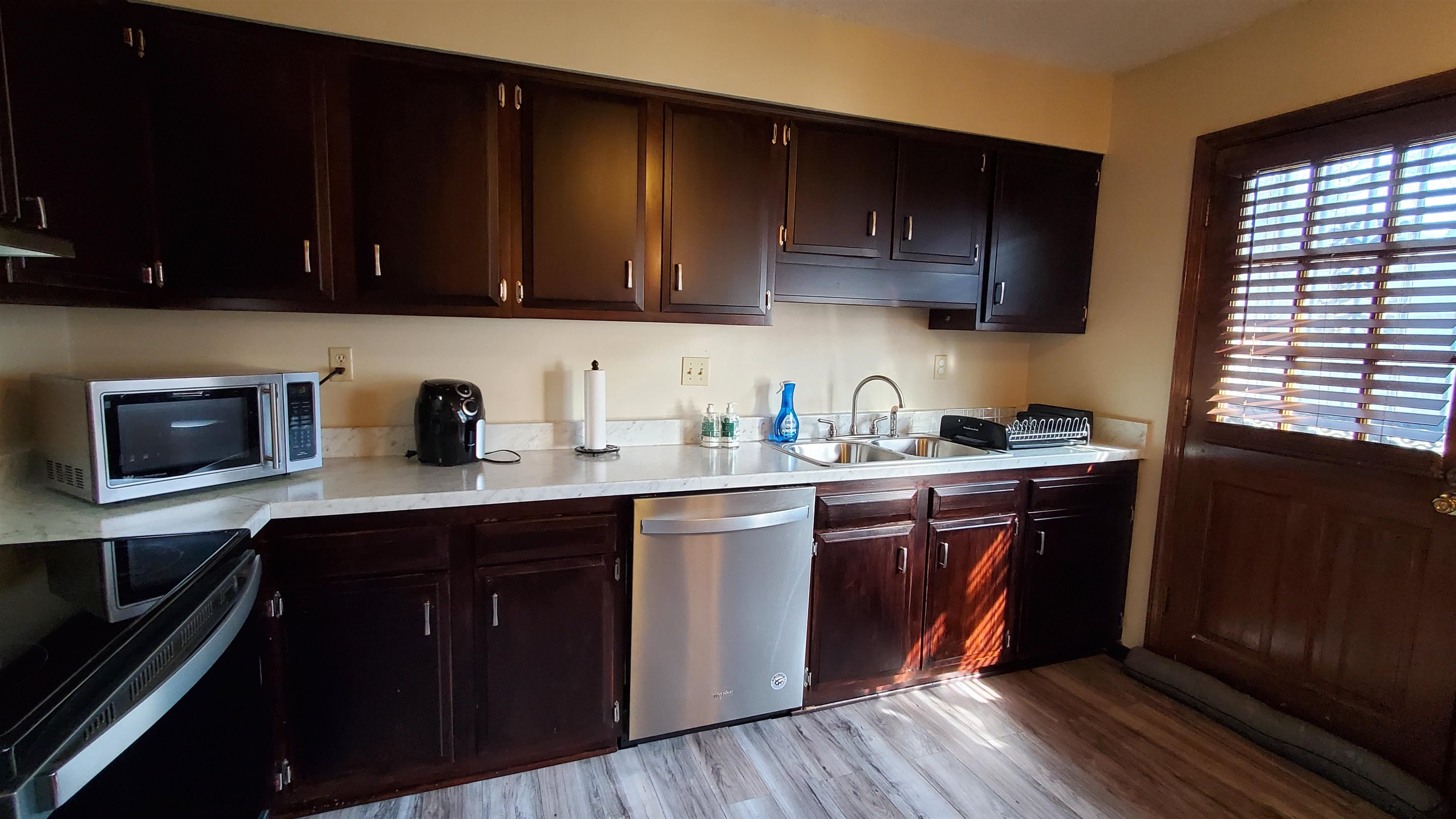 4192 Shadowfall Drive Memphis, TN 38141 - Photo 11 of 24 a kitchen with stainless steel appliances granite countertop wooden cabinets sink and dishwasher a stove top oven with wooden floor