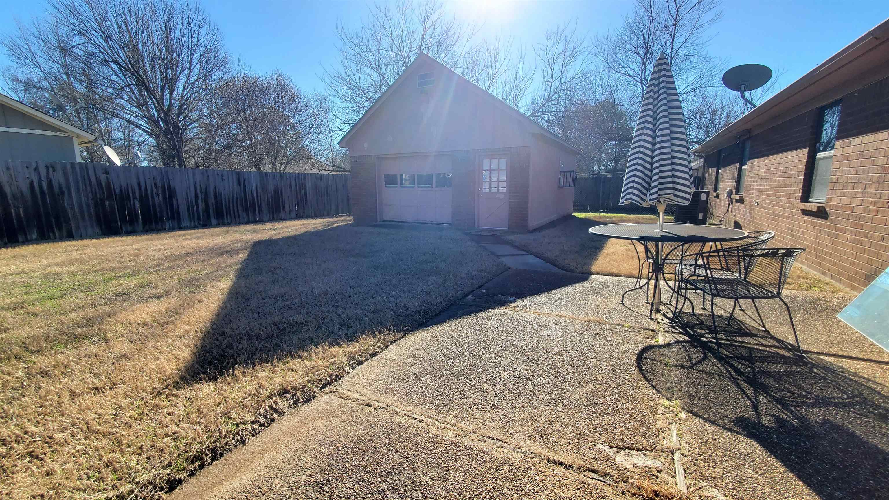 4192 Shadowfall Drive Memphis, TN 38141 - Photo 20 of 24 a backyard of a house with table and chairs