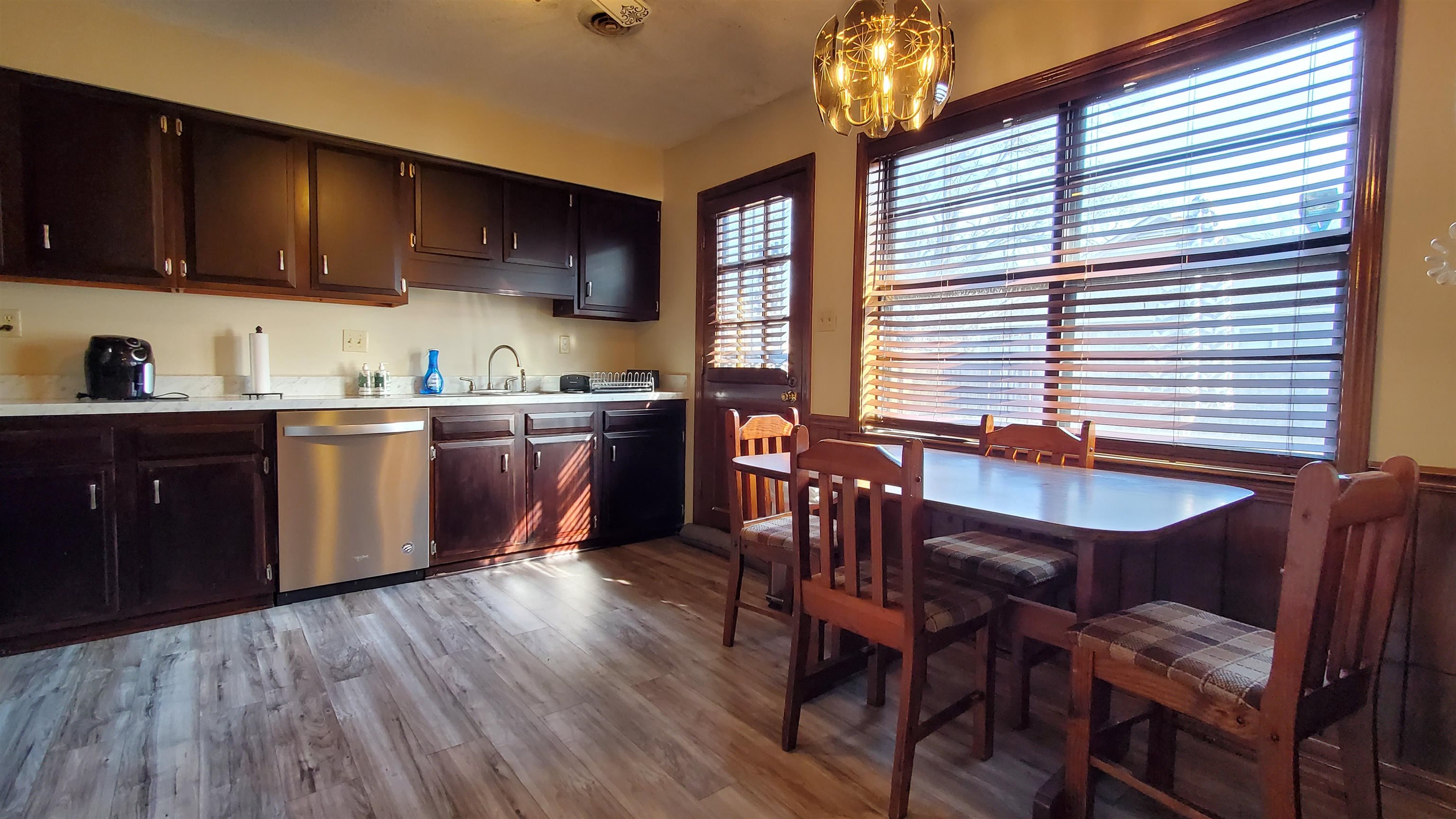 4192 Shadowfall Drive Memphis, TN 38141 - Photo 8 of 24 a kitchen with stainless steel appliances granite countertop wooden floors a stove a sink a dining table and chairs
