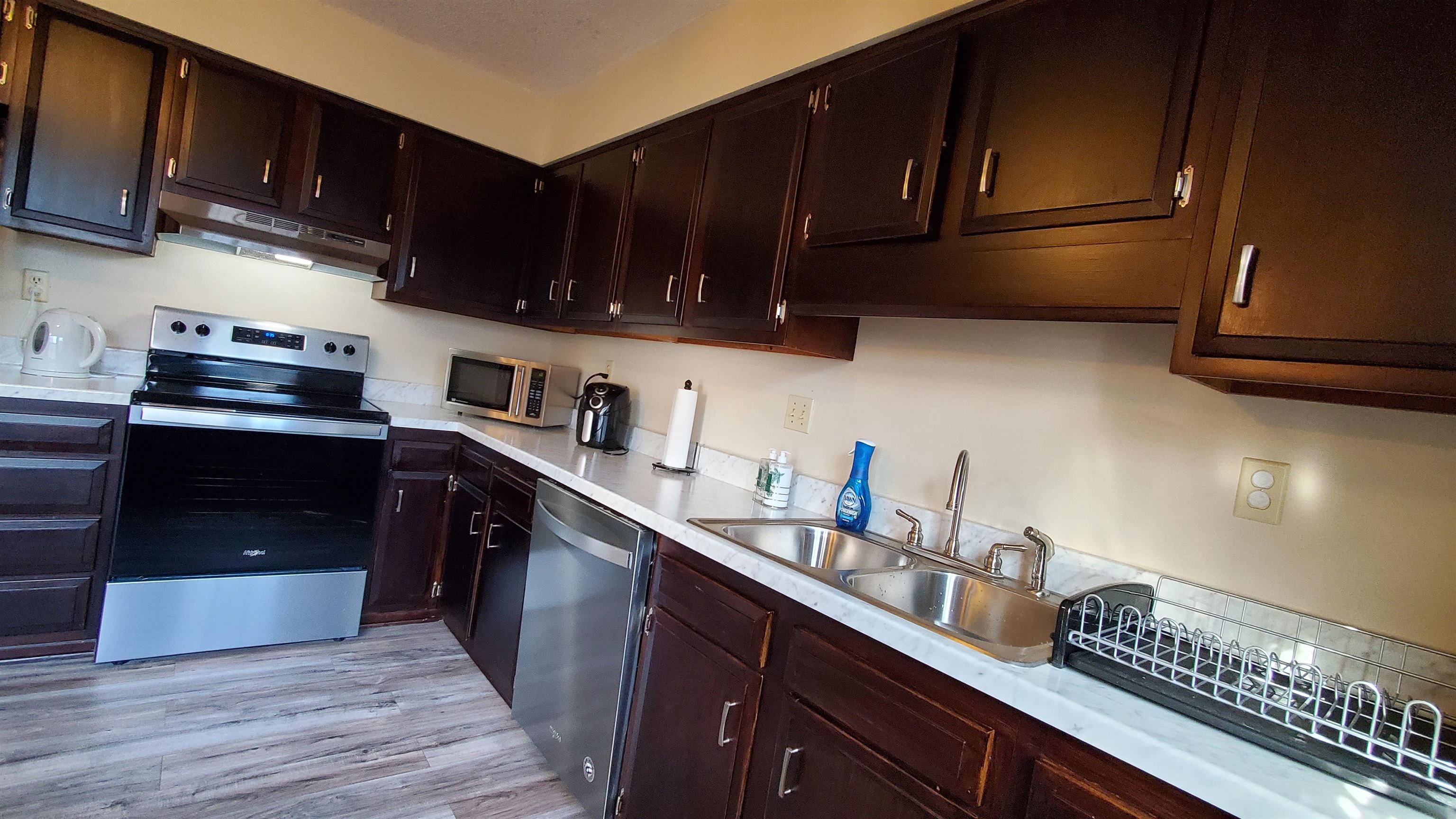 4192 Shadowfall Drive Memphis, TN 38141 - Photo 10 of 24 a kitchen with granite countertop stainless steel appliances and wooden cabinets