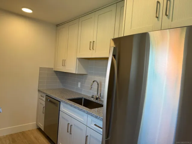 a kitchen with a sink and a refrigerator