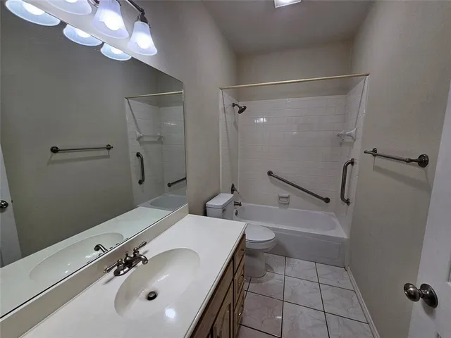 a bathroom with a tub a sink and mirror