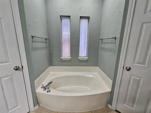 a white bath tub sitting in a bathroom