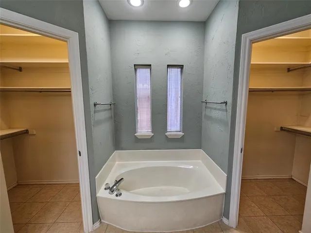 a bathroom with a tub and shower