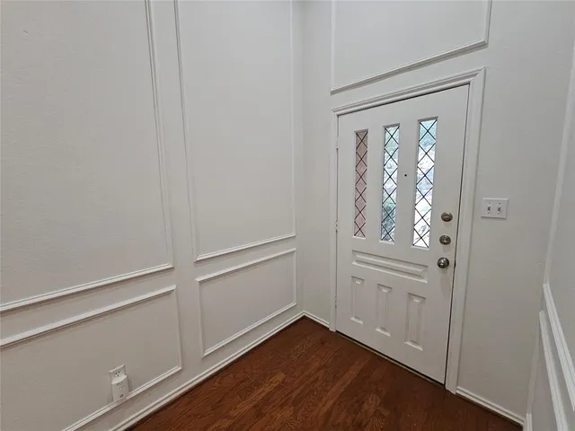 a view of front door with wooden floor