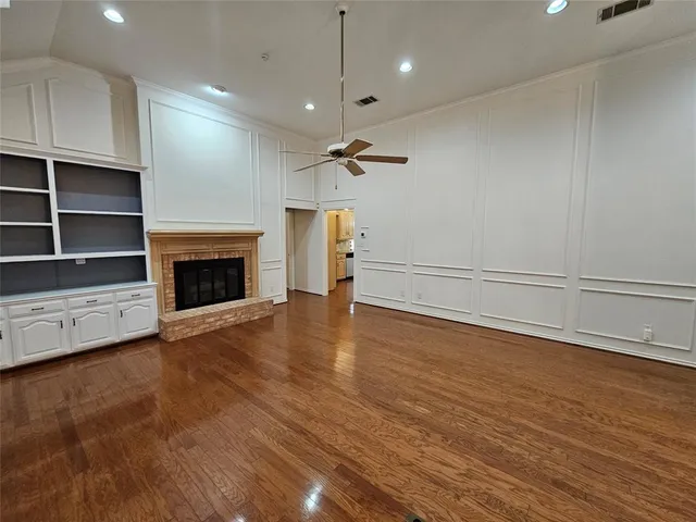a view of a livingroom with a fireplace and a ceiling fan