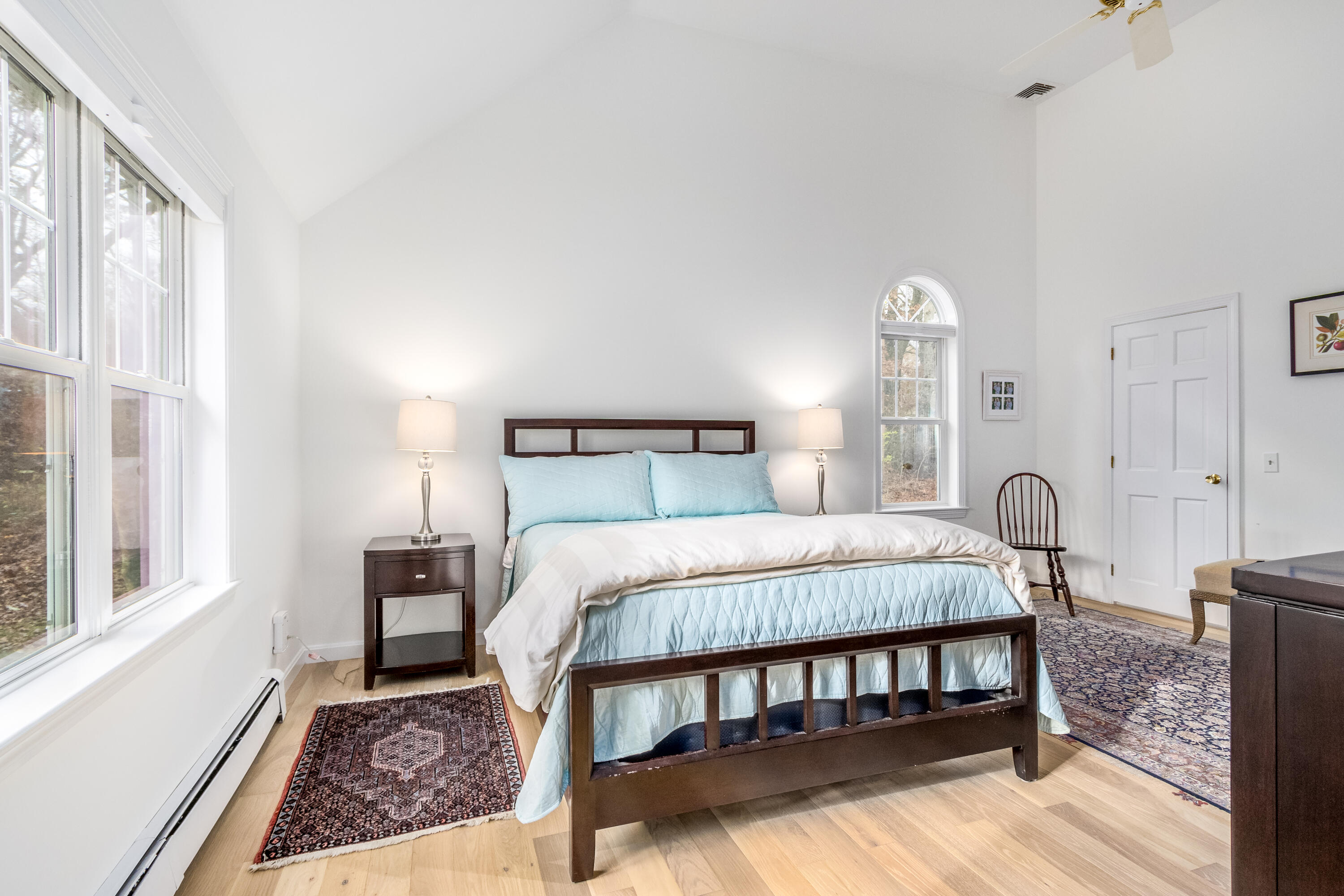 189 Dromoland Lane Barnstable, MA 02630 - Photo 17 of 40 a bedroom with a bed two lamps and a large window