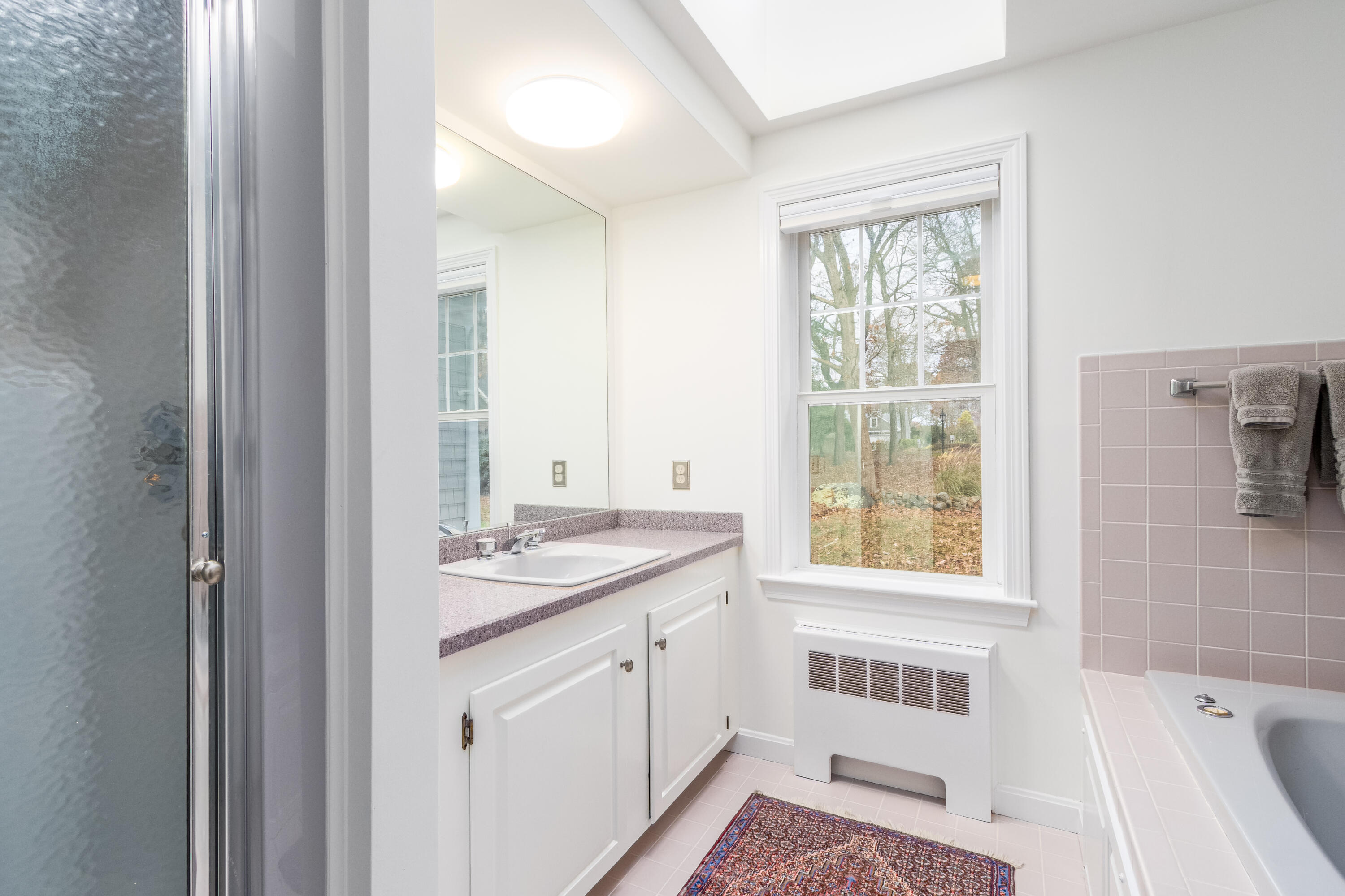189 Dromoland Lane Barnstable, MA 02630 - Photo 19 of 40 a bathroom with a granite countertop sink and a window