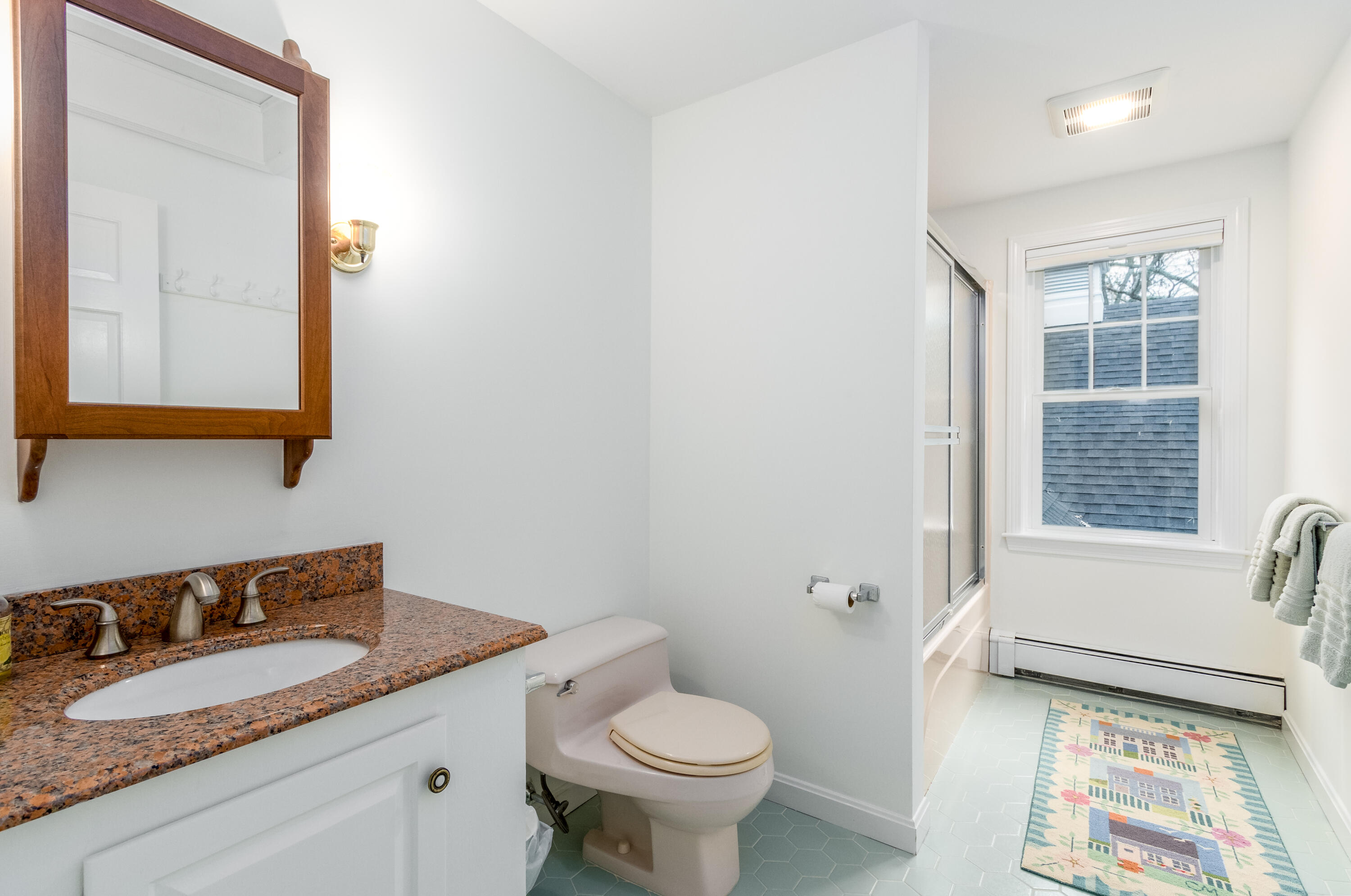 189 Dromoland Lane Barnstable, MA 02630 - Photo 30 of 40 a bathroom with a granite countertop sink mirror vanity and toilet