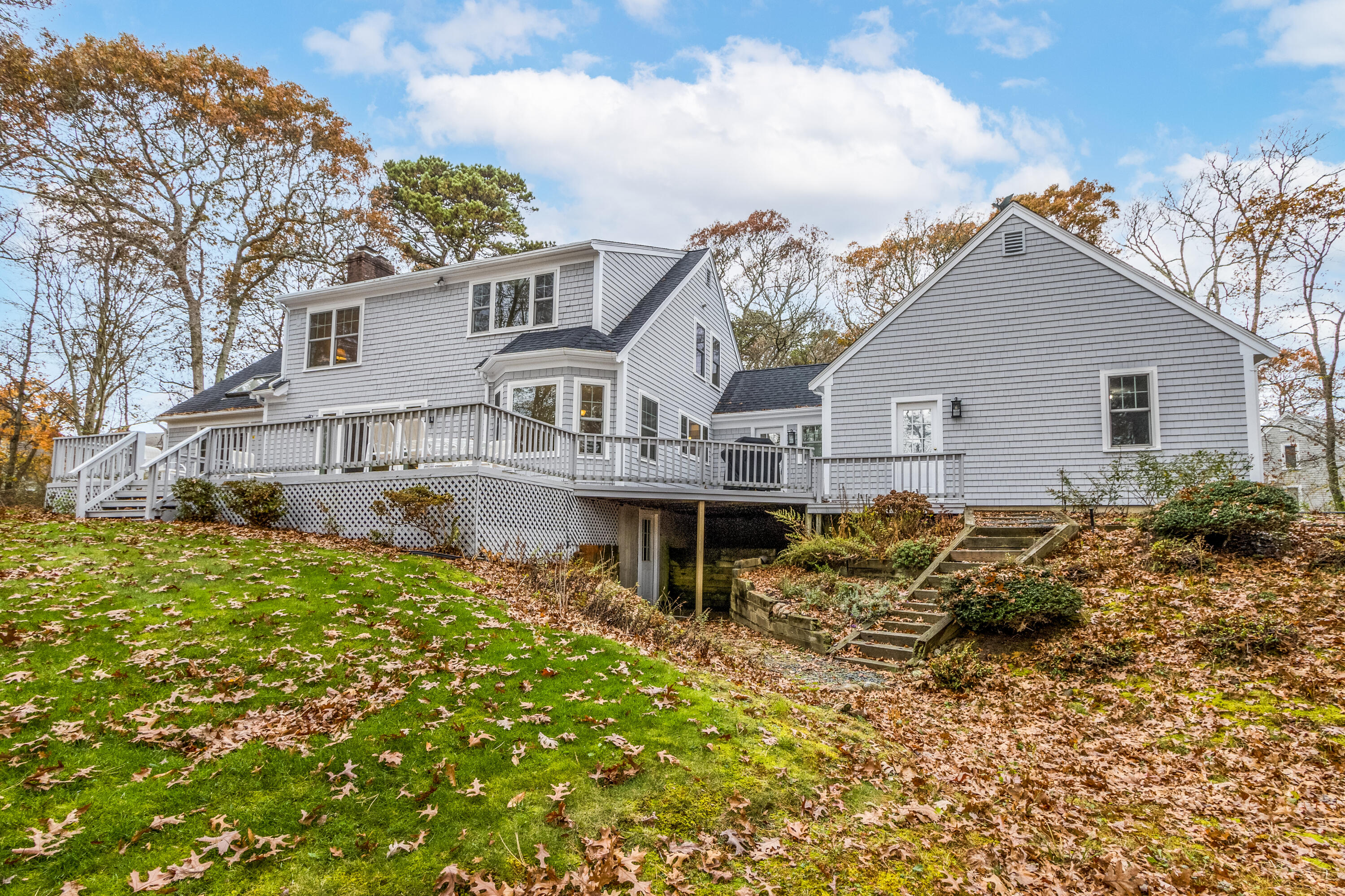 189 Dromoland Lane Barnstable, MA 02630 - Photo 33 of 40 a view of a white house next to a yard with potted plants