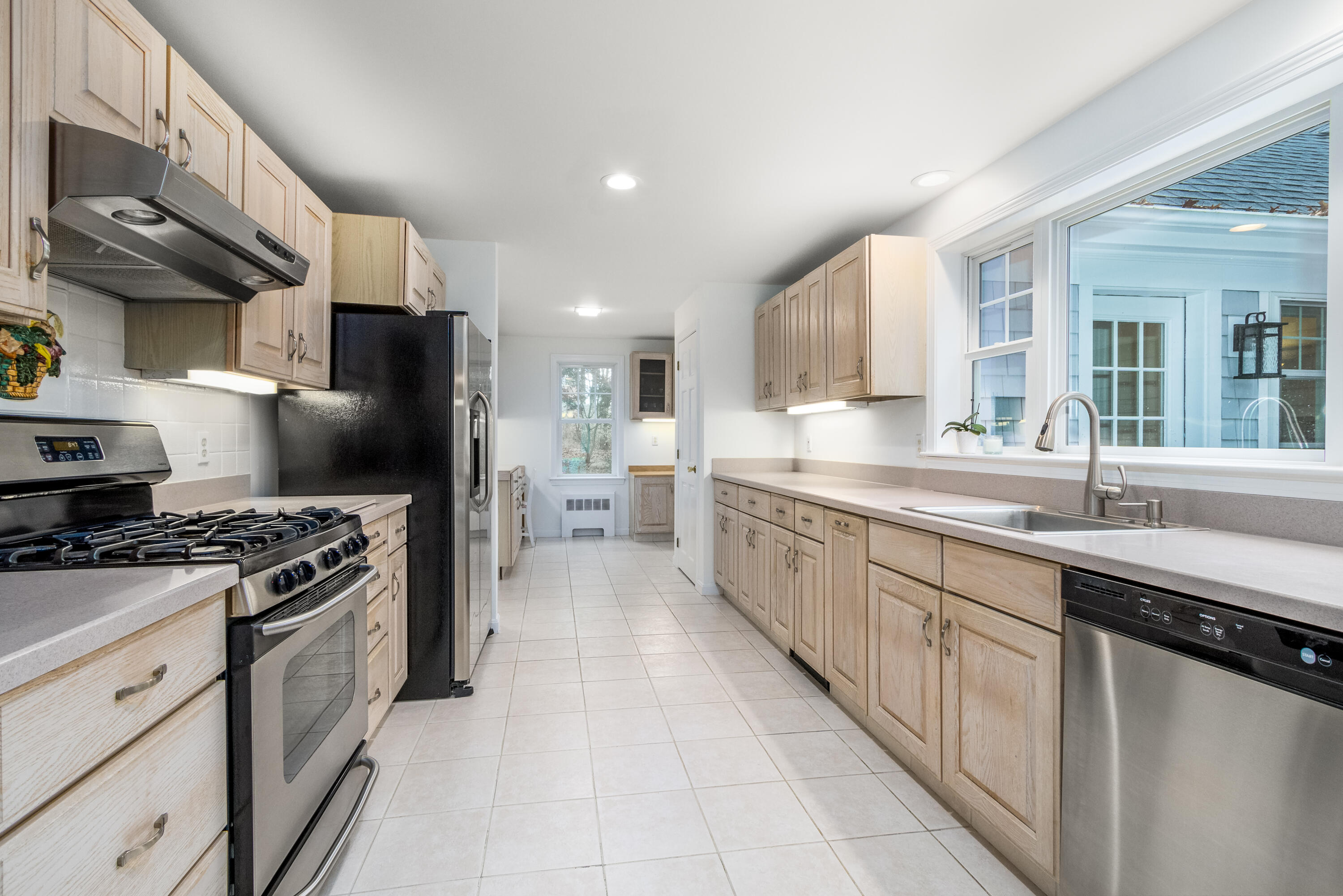189 Dromoland Lane Barnstable, MA 02630 - Photo 8 of 40 a large kitchen with stainless steel appliances granite countertop a stove a sink dishwasher and a refrigerator