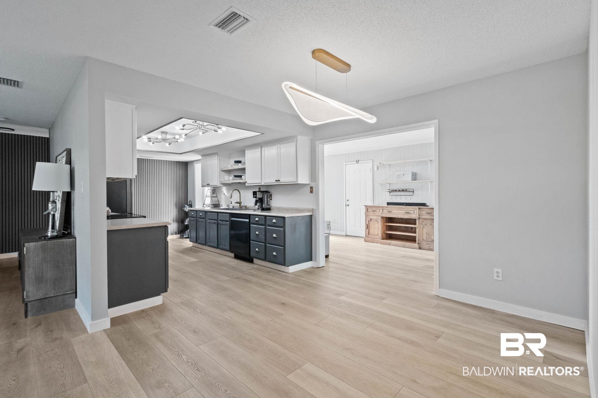 524 Ariel Avenue Foley, AL 36535 - Photo 13 of 37 Open-concept living space featuring wood-finish flooring, a modern linear pendant light, and recessed lighting