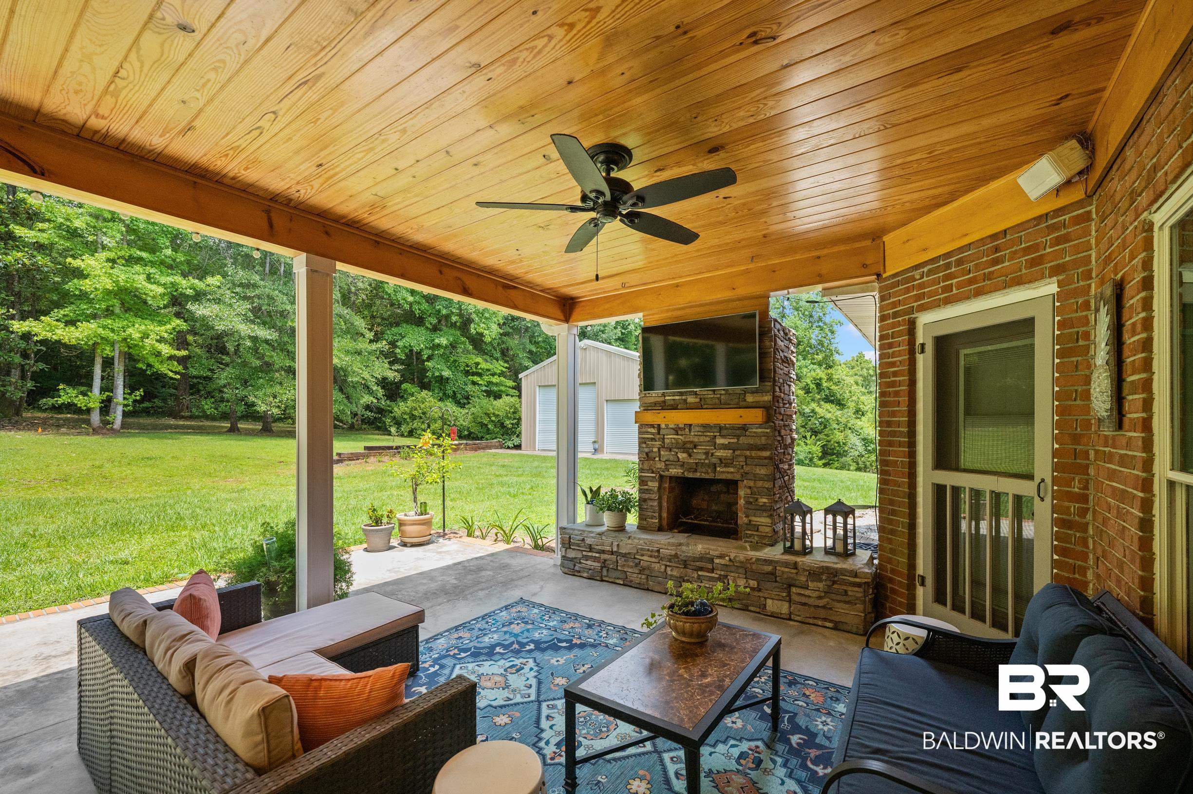 196 Morning Ridge Road Monroeville, AL 36460 - Photo 62 of 71 View of patio featuring an outdoor living space with a fireplace and view of wooded area