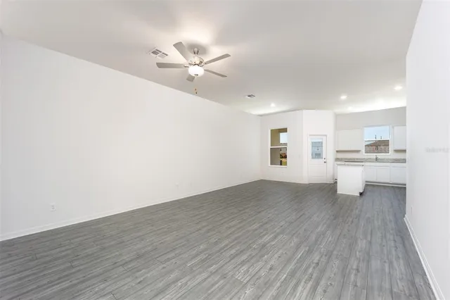 a view of a kitchen with a sink and wooden floor