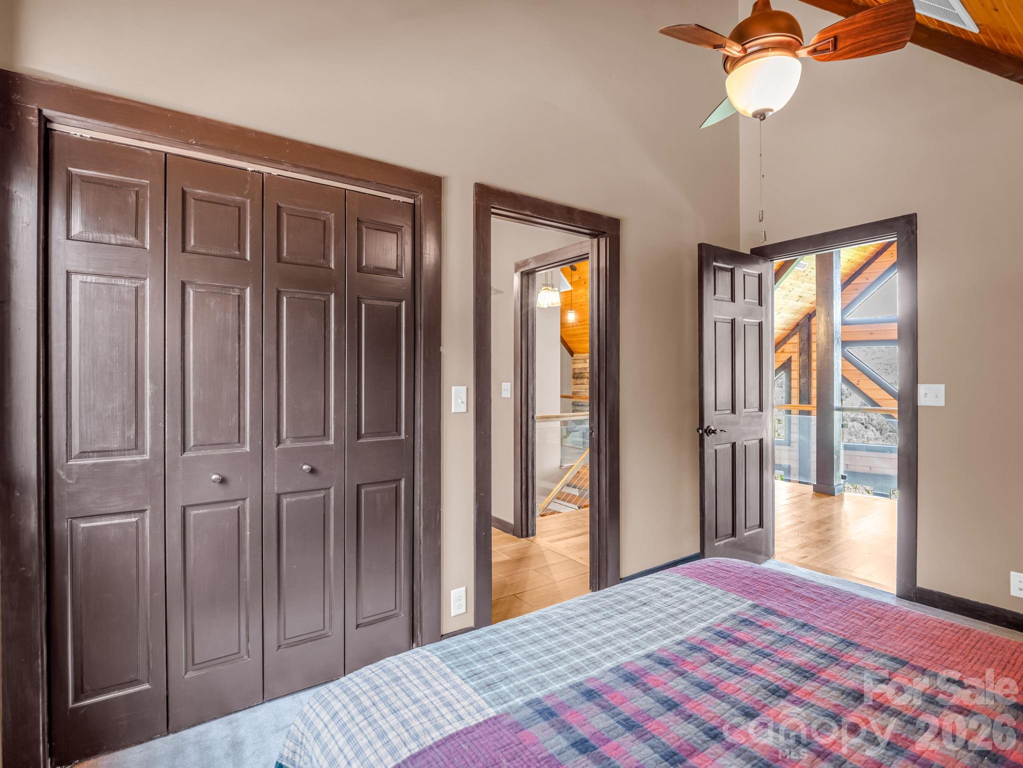 590 Boulder Ridge Lake Lure, NC 28746 - Photo 29 of 48 a bedroom with a bed and a chandelier