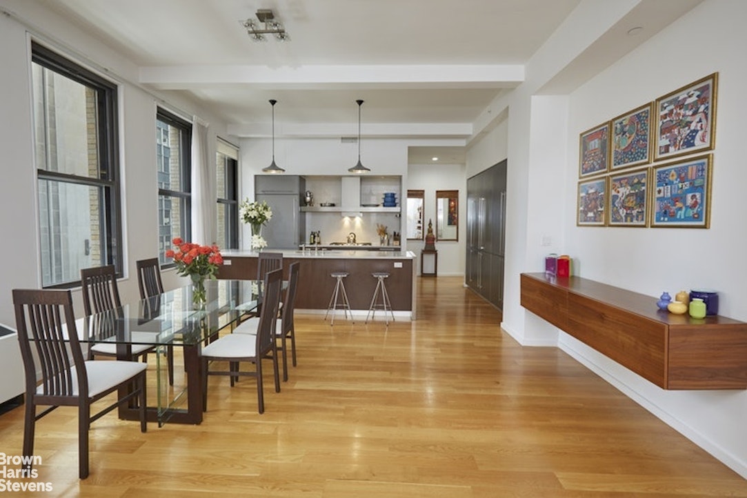 76 Madison Avenue, Unit 4A Manhattan, NY 10016 - Photo 2 of 19 a dining hall with stainless steel appliances kitchen island granite countertop a dining table and chairs