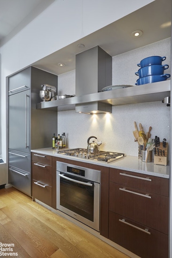 76 Madison Avenue, Unit 4A Manhattan, NY 10016 - Photo 4 of 19 a kitchen with stainless steel appliances granite countertop a stove and a sink