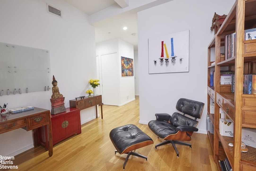 76 Madison Avenue, Unit 4A Manhattan, NY 10016 - Photo 5 of 19 a living room with furniture and a mirror
