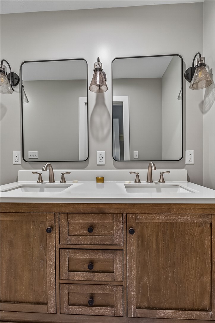 8700 Quaker Trace Road Camden, OH 45311 - Photo 18 of 34 This primary bathroom offers dual sinks, generous counter space, and a functional vanity for your daily routine.