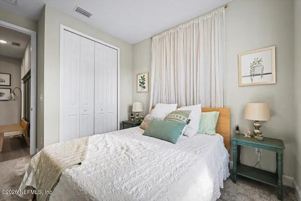 a bedroom with a bed and a window