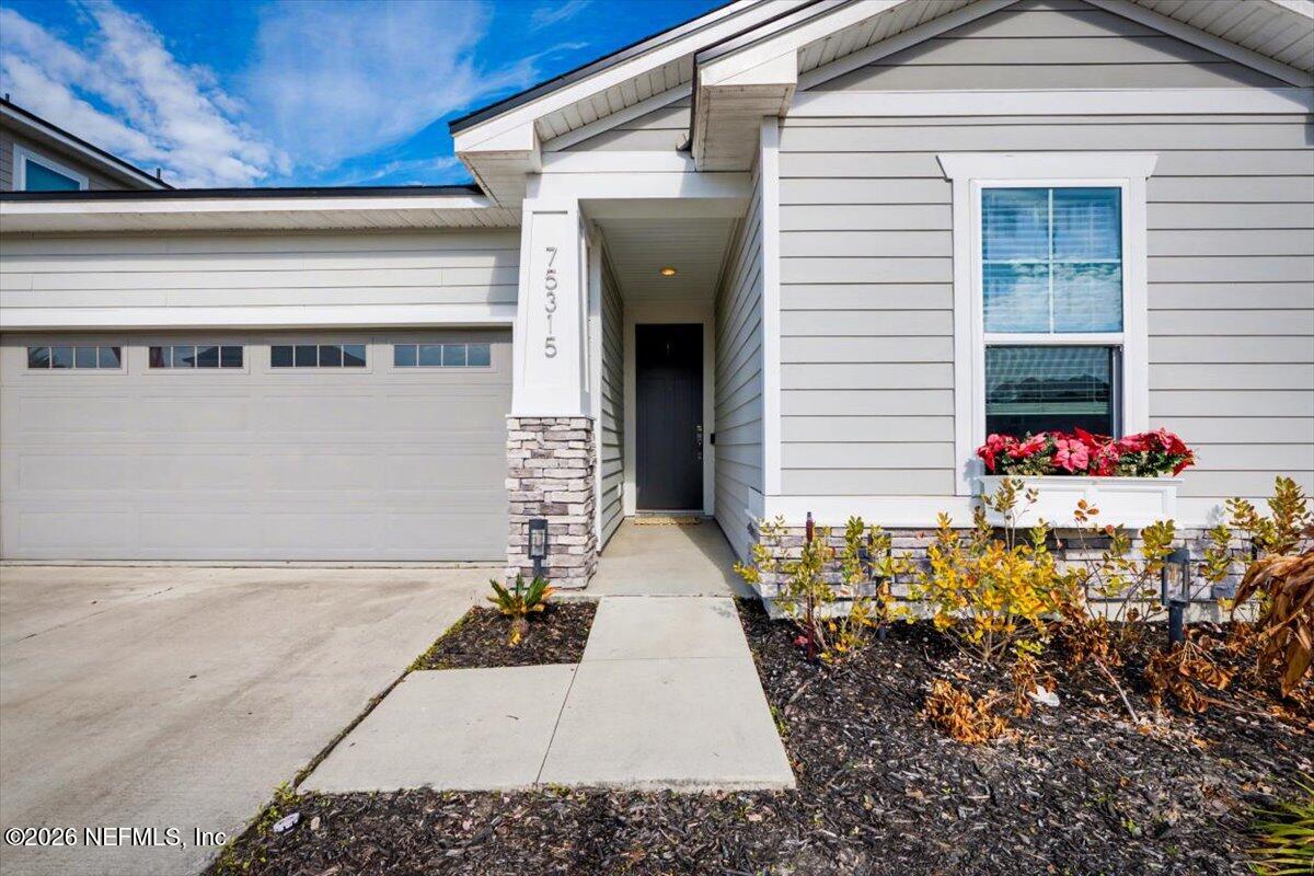 75315 Plumbago Yulee, FL 32097 - Photo 2 of 37 a front view of a house with a garage