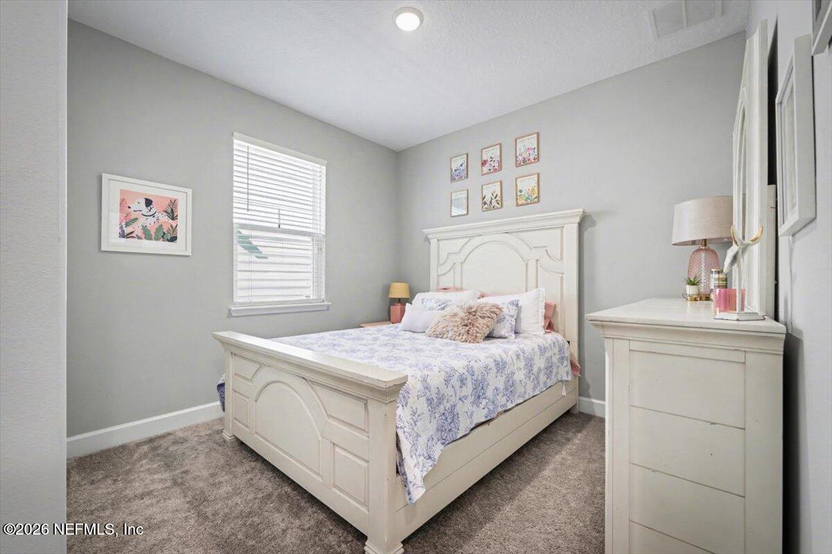 75315 Plumbago Yulee, FL 32097 - Photo 23 of 37 a bedroom with a bed and a window