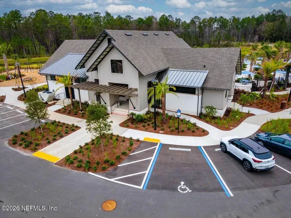 a sign that is sitting in front of flowers