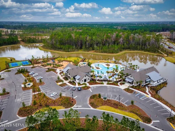 an aerial view of a house with swimming pool and outdoor seating