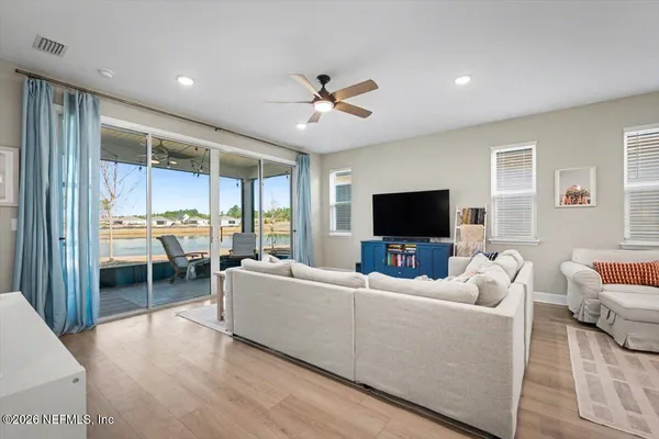 a kitchen with stainless steel appliances granite countertop white cabinets a sink a stove and a refrigerator