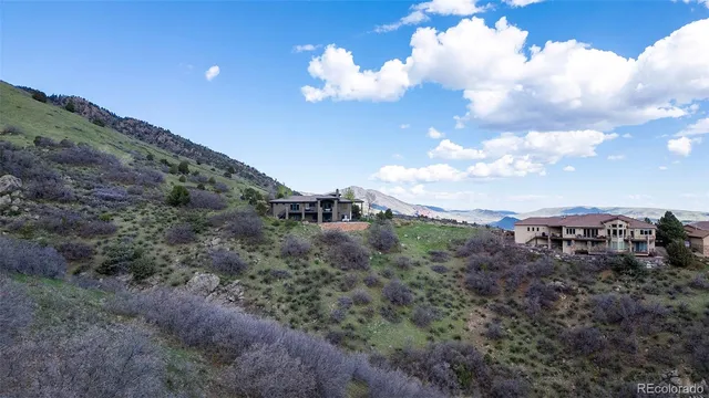 a view of a dry yard with wooden fence