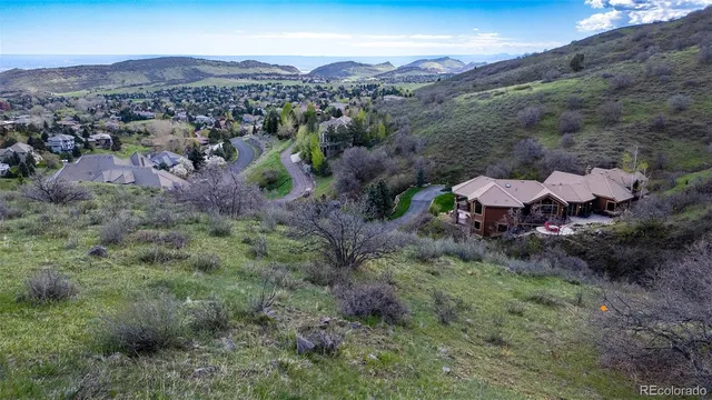 a view of a lush green hillside and houses