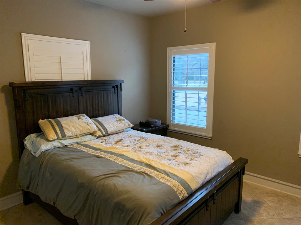 3407 Bryan Street, Unit E Dallas, TX 75204 - Photo 10 of 12 a bed sitting in a bedroom next to a window