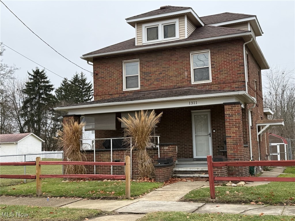 1311 Warner Road Southeast Canton, OH 44707 - Photo 13 of 14 Traditional style home featuring covered porch, brick siding, and roof with shingles