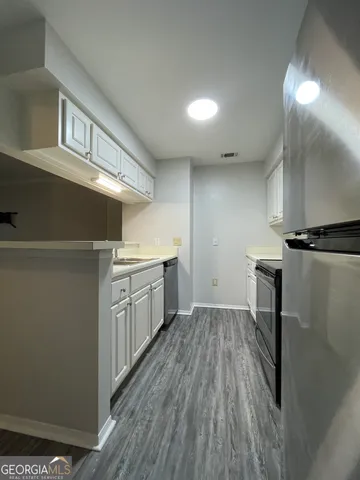 a kitchen with a sink and a refrigerator