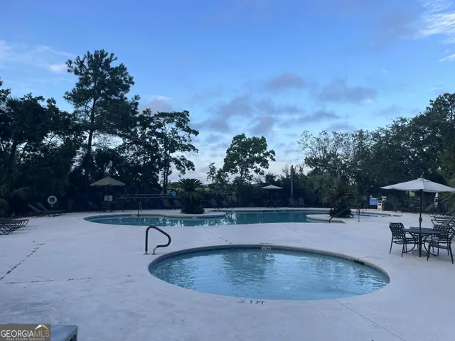 a view of outdoor space with wooden floor and seating