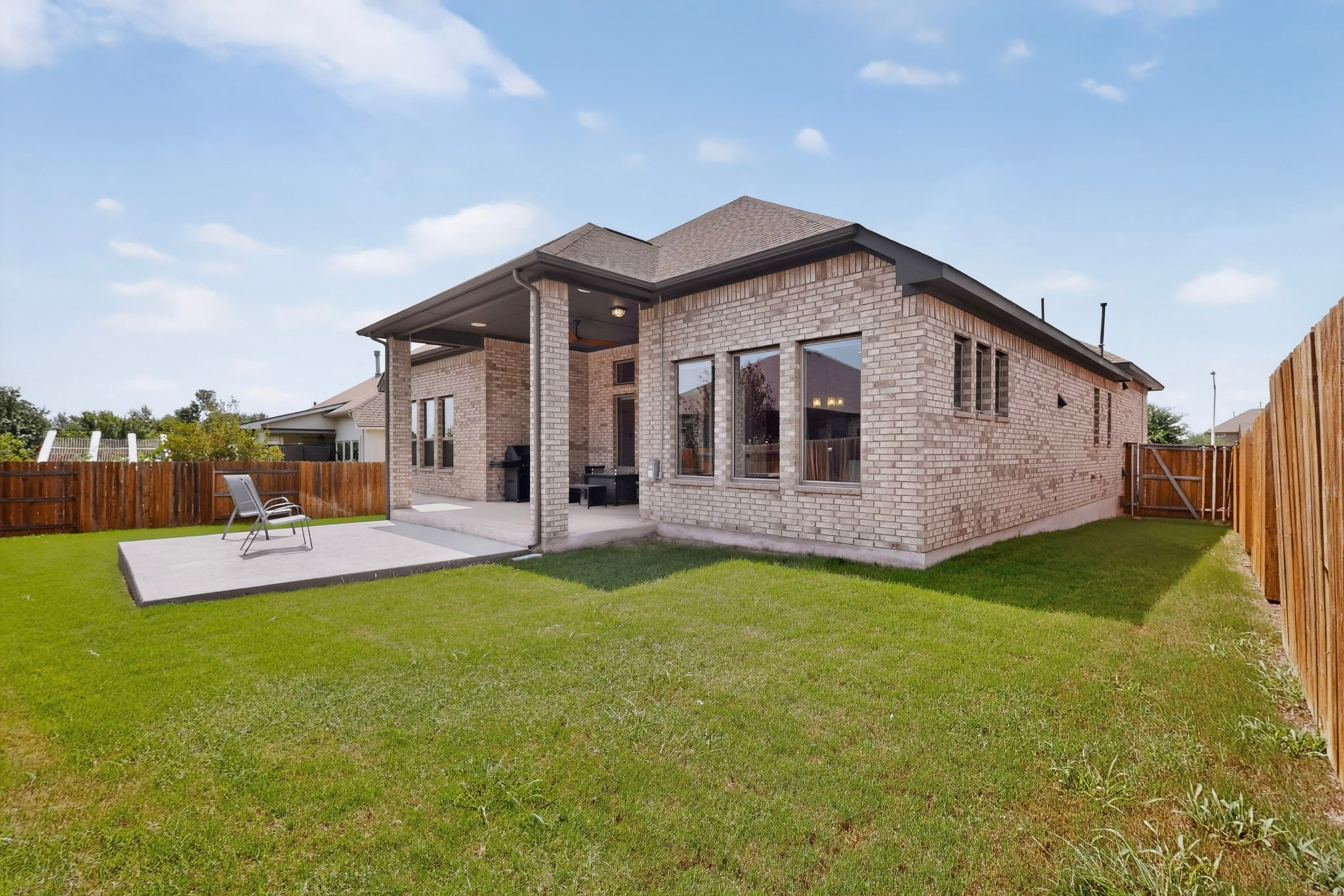 2433 La Mirada Street Leander, TX 78641 - Photo 23 of 25 An inviting rear facade with a covered patio, perfect for outdoor relaxation.