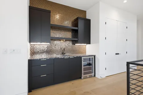 a kitchen with stainless steel appliances granite countertop a refrigerator and a sink