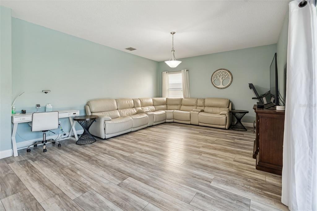 3620 Lefays Point Land O Lakes, FL 34638 - Photo 13 of 50 a living room with furniture a window and wooden floor