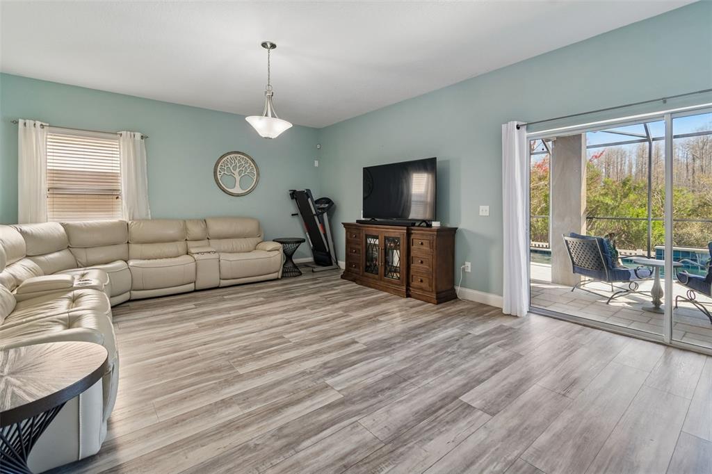 3620 Lefays Point Land O Lakes, FL 34638 - Photo 14 of 50 a living room with furniture a flat screen tv and a large window