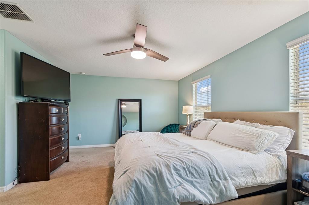 3620 Lefays Point Land O Lakes, FL 34638 - Photo 20 of 50 a bedroom with a bed and a flat tv screen on dresser
