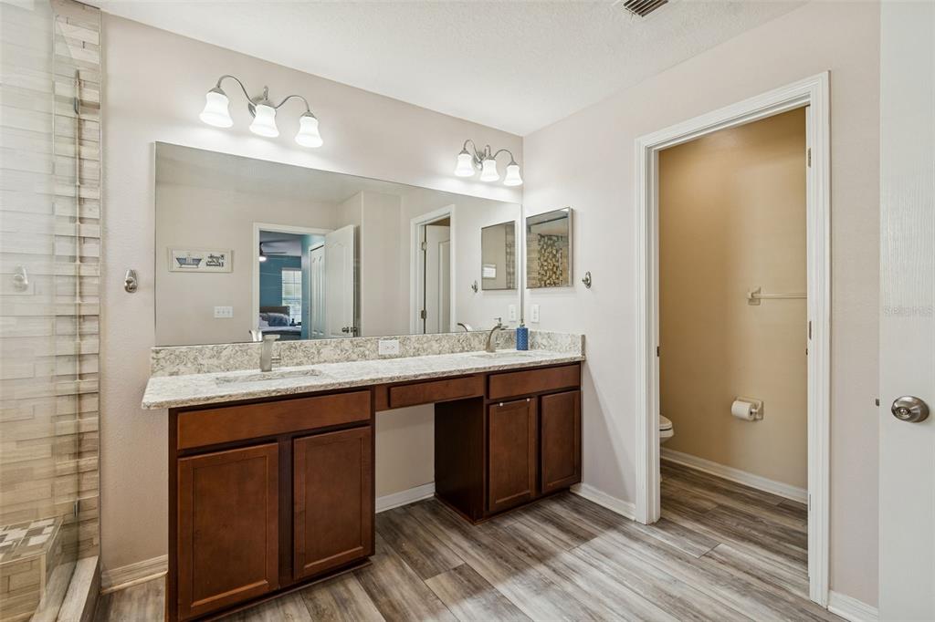 3620 Lefays Point Land O Lakes, FL 34638 - Photo 21 of 50 a bathroom with a double vanity sink and a mirror