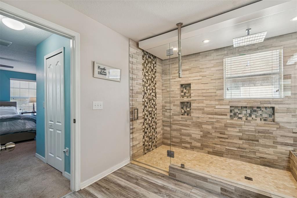 3620 Lefays Point Land O Lakes, FL 34638 - Photo 23 of 50 a bathroom with a bathtub and a shower