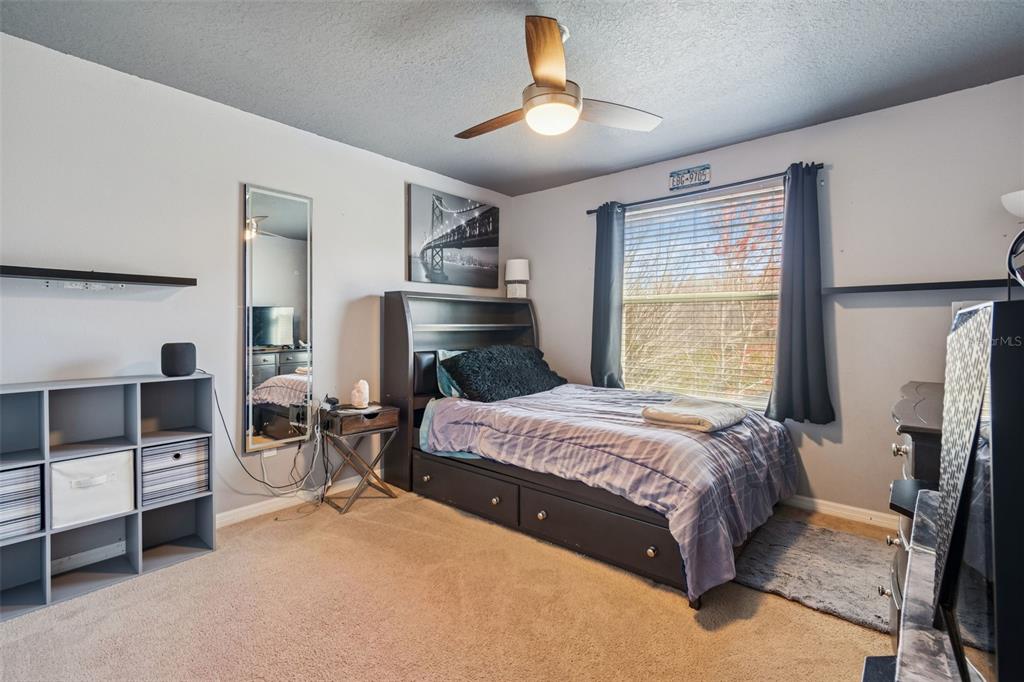 3620 Lefays Point Land O Lakes, FL 34638 - Photo 28 of 50 a bedroom with a bed and a chandelier